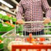 Customer Pushing Cart with Groceries