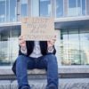 Job loss due to COVID-19 virus pandemic concept. Unrecognizable man holds sign "I lost my job"