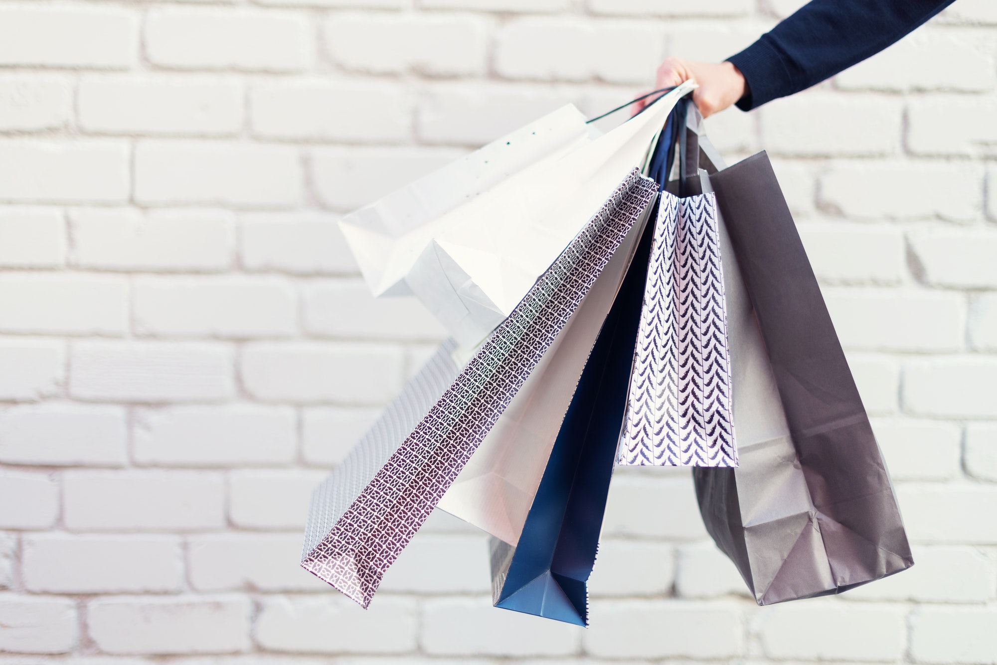 Man with bunch of shopping bags. Copy space. Sale, discount, black friday concept. Shopping mall and