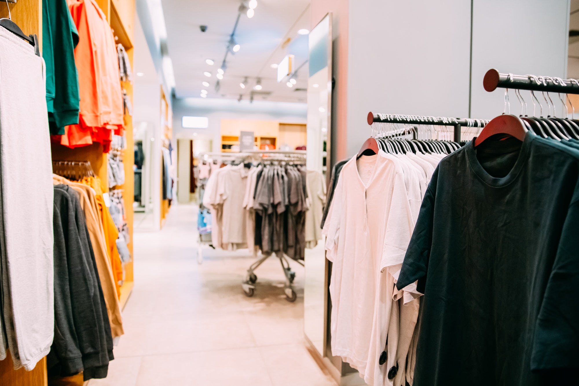 Many Male One-colour T-shirt On Hanger In Store Of Shopping Cent