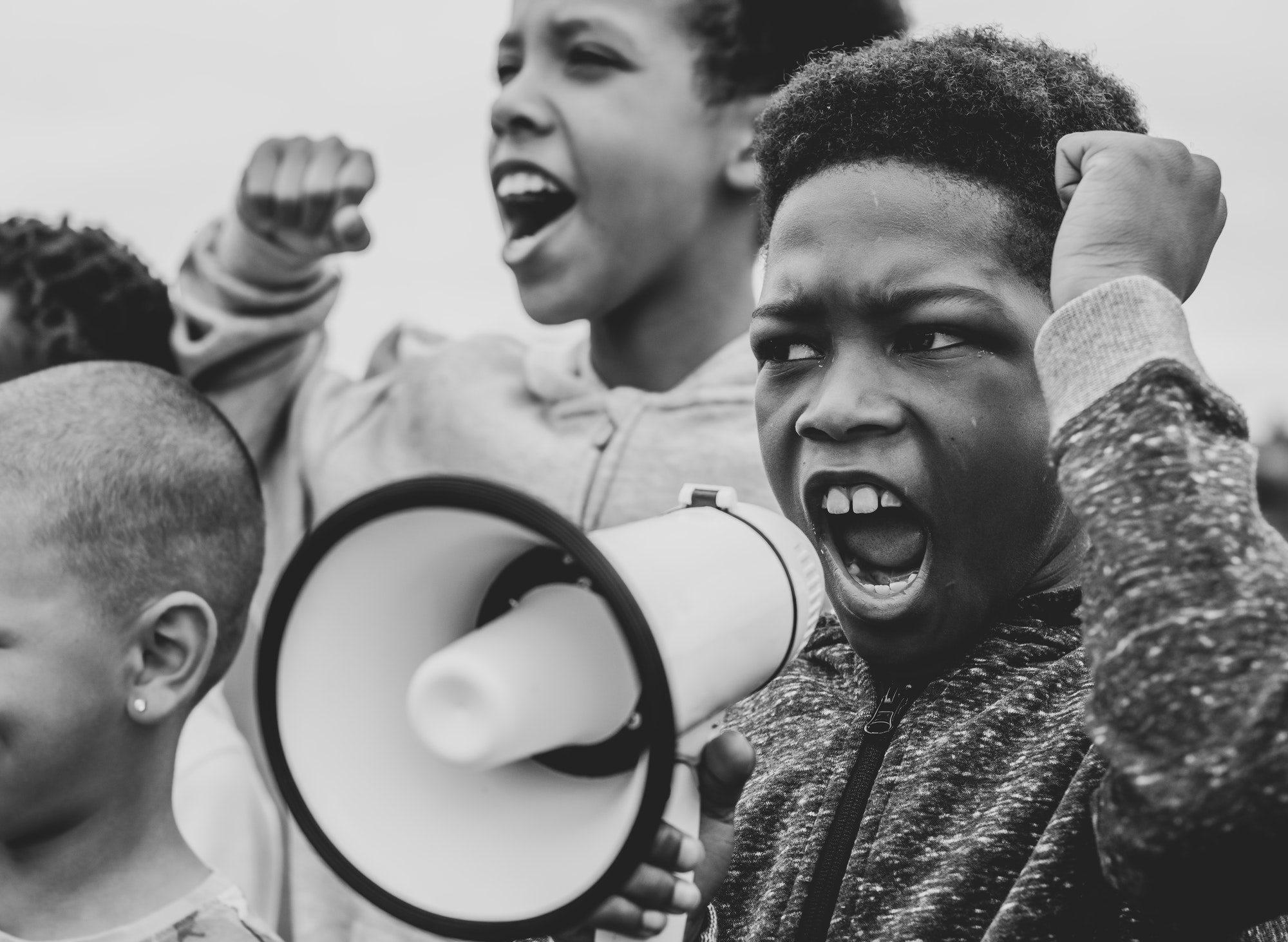 Young boy shouting on a megaphone in a protest