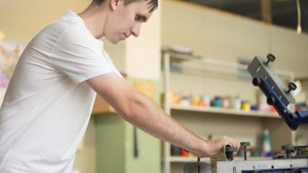 Young man screen printing