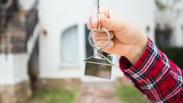 New home, house, property and tenant - Real estate agent handing a house key