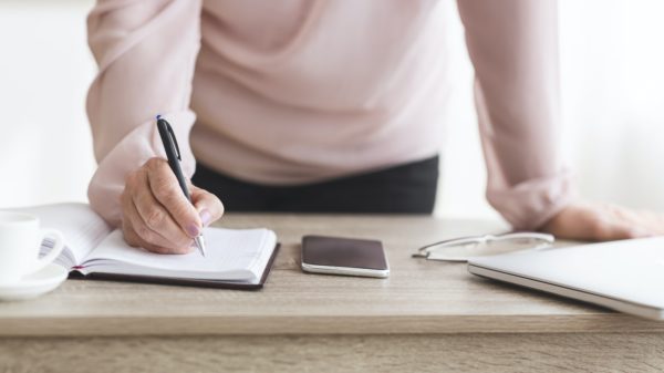 Senior woman writing down tasks for day