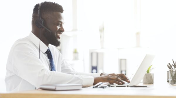 Side view of young customer service agent working in office