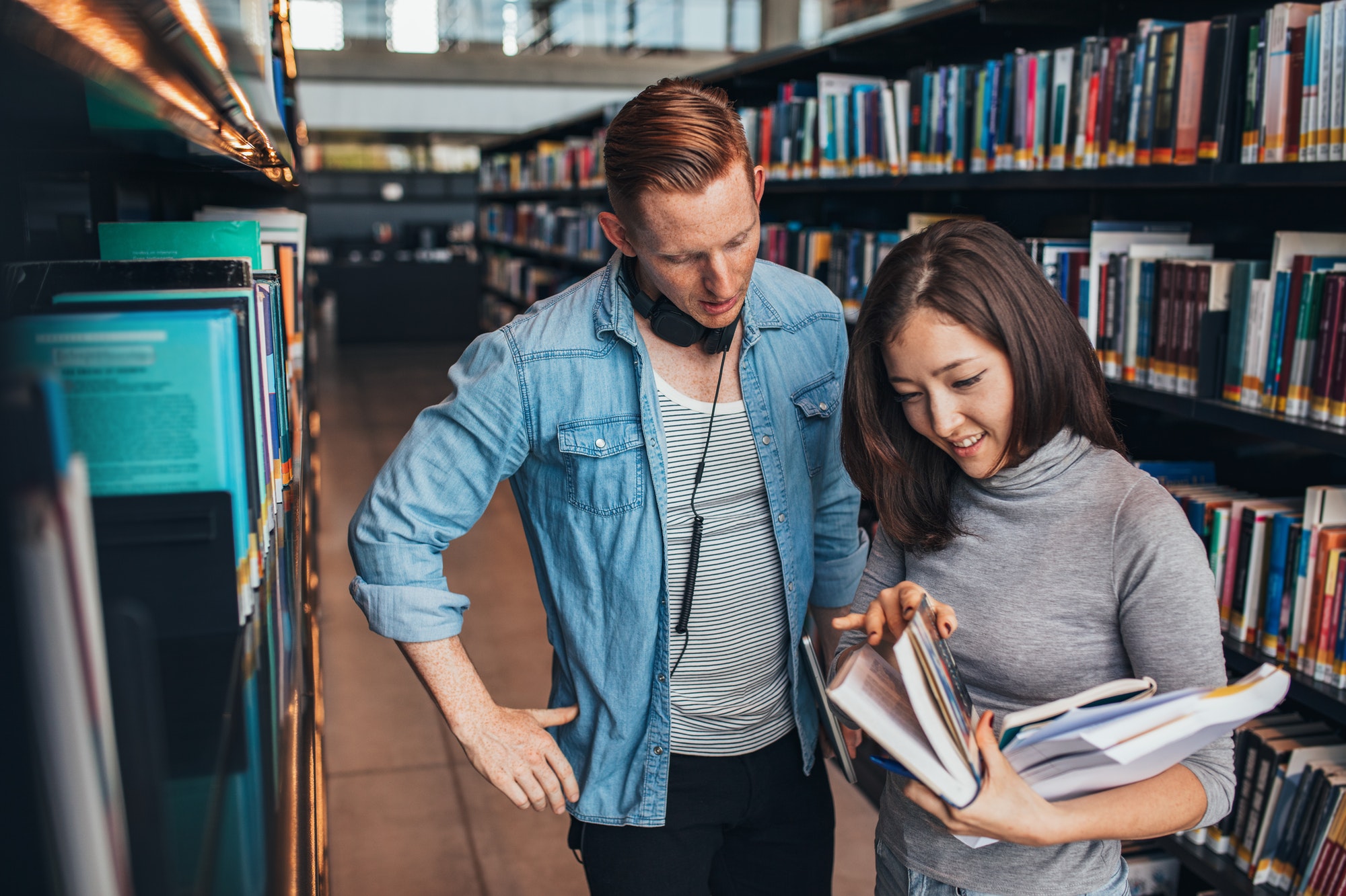 Students choosing a book in a library