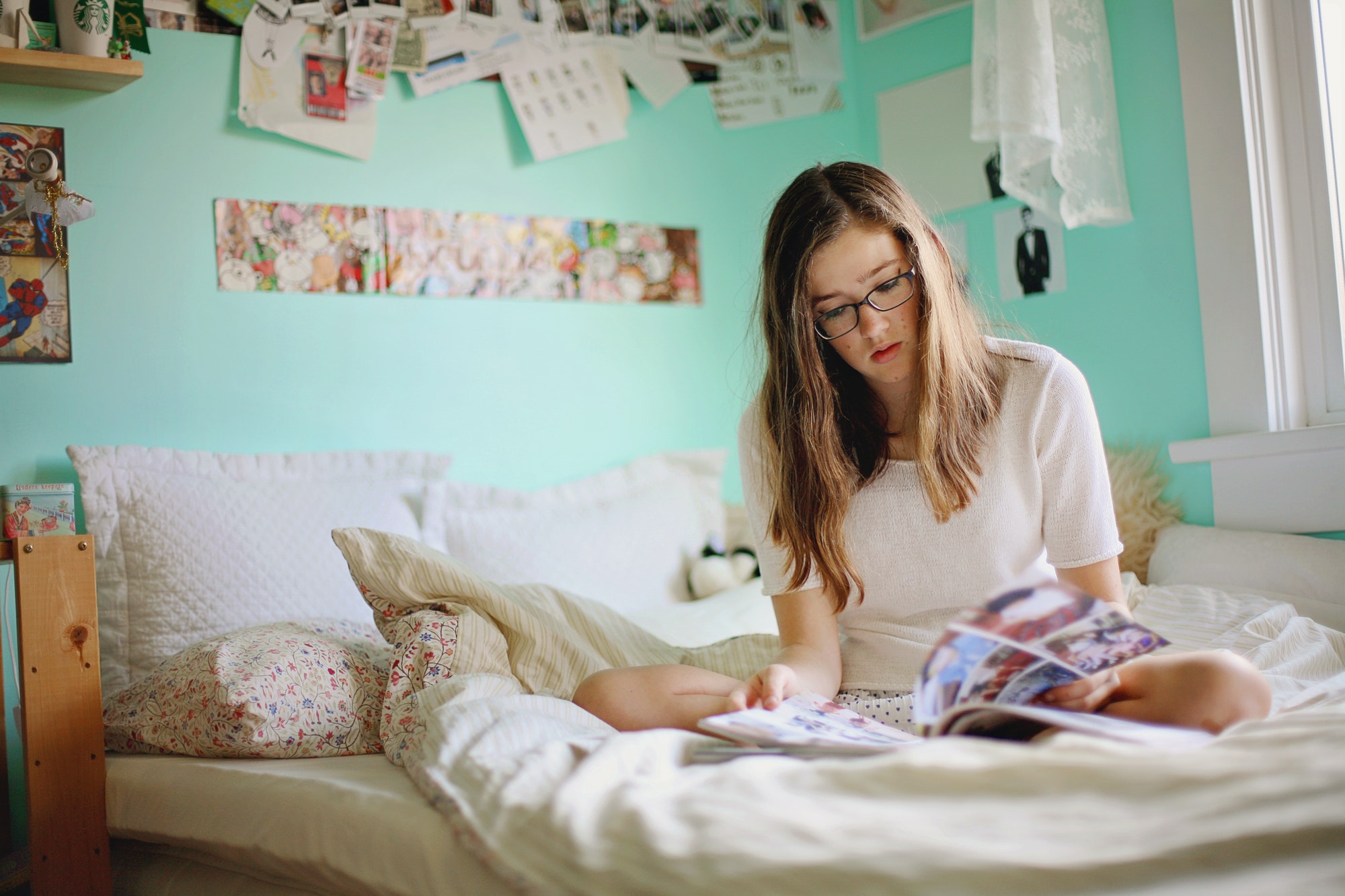 teen reading on her bed