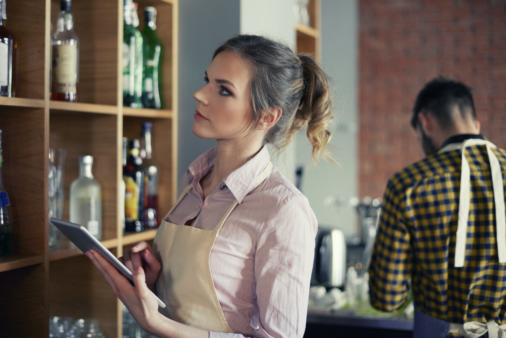 Waitress ordering products by digital tablet