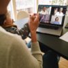 Woman at home video conferencing with colleagues