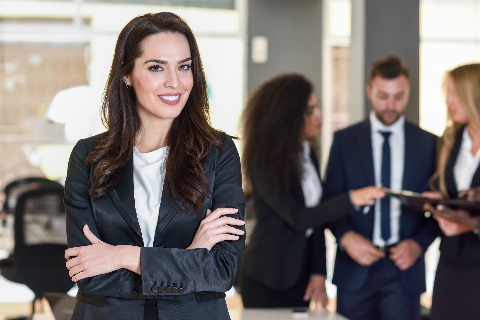 Businesswoman leader in modern office with businesspeople workin