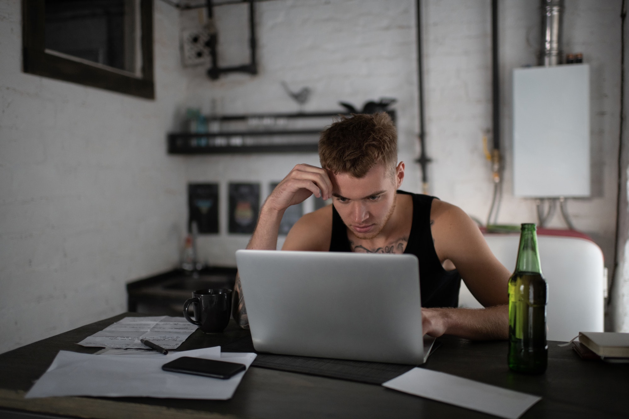 Concentrated freelancer browsing laptop