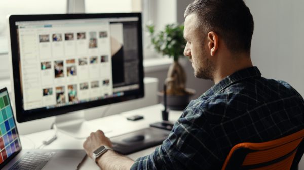 Modern man working remotely on a computer from home office