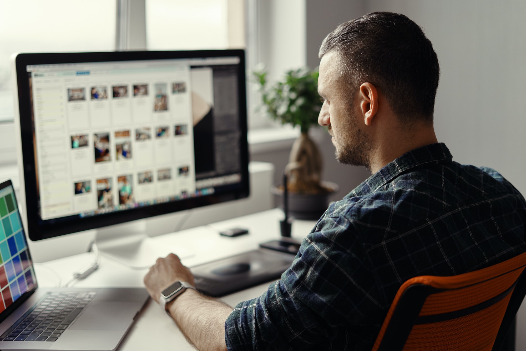 Modern man working remotely on a computer from home office