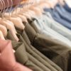 Row of hangers with shirts in a store