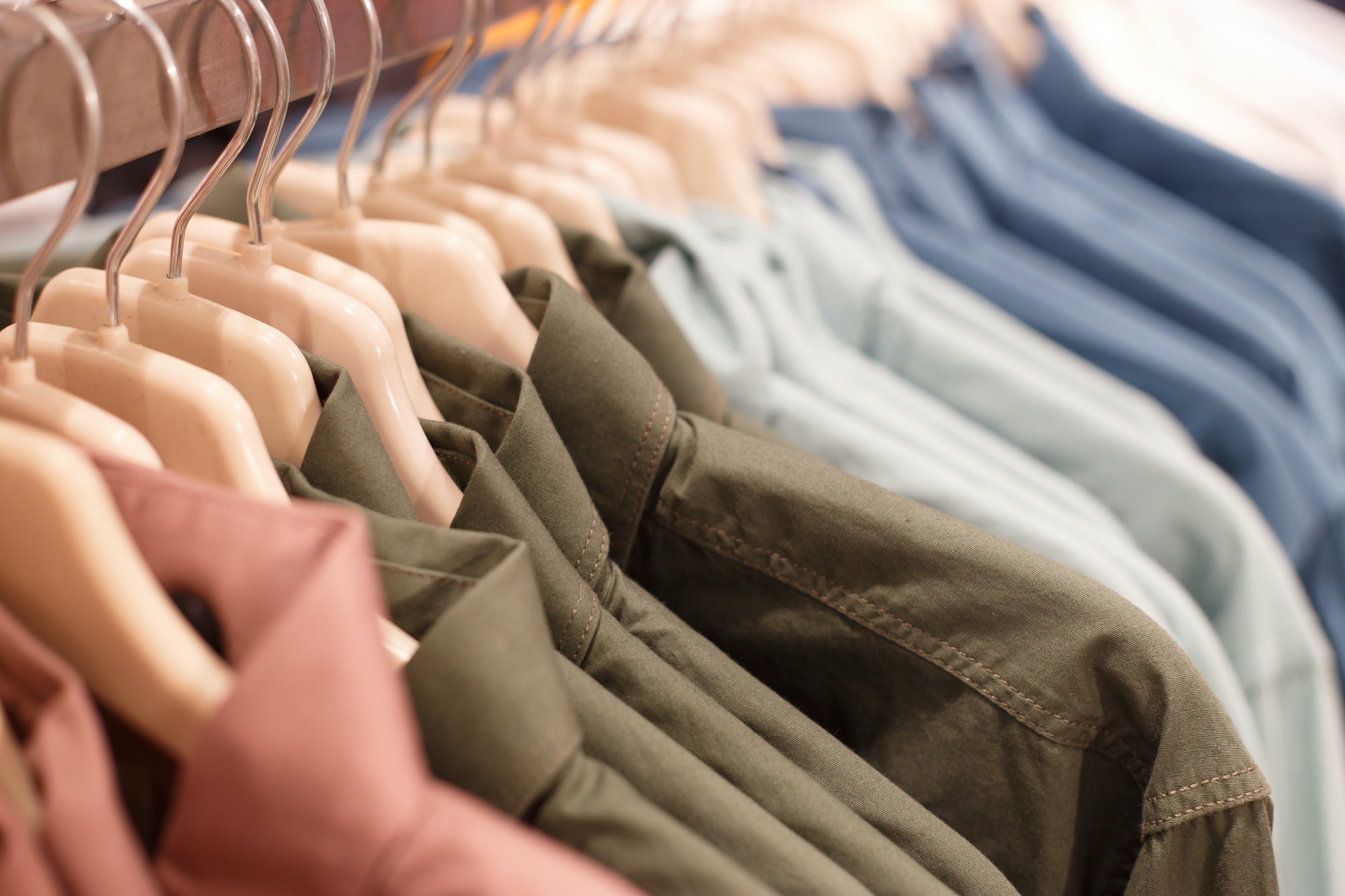 Row of hangers with shirts in a store